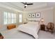 Main bedroom with tray ceiling, large windows and wooden furniture at 314 Pepperwood Way, Canton, GA 30114