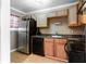 Galley kitchen with stainless steel appliances and wood cabinets at 510 Coventry Rd # 19A, Decatur, GA 30030