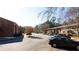 Apartment complex featuring brick buildings and ample parking on a sunny day at 510 Coventry Rd # 19A, Decatur, GA 30030