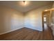 Simple bedroom with wood-look floors and access to hallway at 8263 Canyon Forge Dr, Riverdale, GA 30274