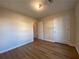 Light and airy bedroom with wood-look floors and closet at 8263 Canyon Forge Dr, Riverdale, GA 30274