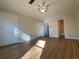 Spacious bedroom with wood-look floors and access to bathroom at 8263 Canyon Forge Dr, Riverdale, GA 30274