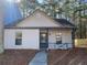 Tan house with gray door and walkway, surrounded by trees at 8263 Canyon Forge Dr, Riverdale, GA 30274