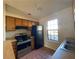 Kitchen with wood cabinets, stainless steel appliances and tile floor at 8263 Canyon Forge Dr, Riverdale, GA 30274