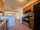 Kitchen area with stainless steel appliances and view of the living room at 8263 Canyon Forge Dr, Riverdale, GA 30274