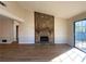 Living room featuring a stone fireplace and sliding glass doors at 8263 Canyon Forge Dr, Riverdale, GA 30274