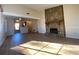 Living room with hardwood floors, stone fireplace and kitchen access at 8263 Canyon Forge Dr, Riverdale, GA 30274