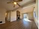 Living room with hardwood floors, stone fireplace, and access to other rooms at 8263 Canyon Forge Dr, Riverdale, GA 30274