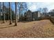 Spacious backyard with large trees and wooden fence at 103 Ashwood N Ct, Stockbridge, GA 30281