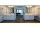 Double vanity bathroom with large mirrors and access to bedroom at 103 Ashwood N Ct, Stockbridge, GA 30281