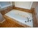 Bathroom with an oval jetted tub and tile surround at 103 Ashwood N Ct, Stockbridge, GA 30281