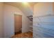 Laundry room with wire shelving and access to a small bathroom at 103 Ashwood N Ct, Stockbridge, GA 30281