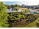 Aerial view of a community with a pond, playground, and homes at 130 Rolison Way, Fayetteville, GA 30214