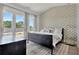 Spacious bedroom with patterned wall, large windows, and a comfortable bed at 130 Rolison Way, Fayetteville, GA 30214