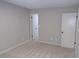 Bedroom with neutral walls, carpeted floor, and two white doors, providing a blank canvas for personalization at 2482 Northlake Ct, Atlanta, GA 30345