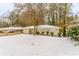 Ranch style home with red front door, snow covered yard at 2792 Plantation Dr, Atlanta, GA 30344