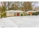 Ranch style home with red front door, snow covered yard at 2792 Plantation Dr, Atlanta, GA 30344