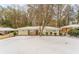 Ranch style home with red front door, snow covered yard at 2792 Plantation Dr, Atlanta, GA 30344