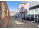 Backyard view of townhomes featuring private patios and shared green space at 915 Highwood Ln, Atlanta, GA 30344