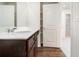 Bathroom features a dark wood vanity with modern faucet and lighting at 915 Highwood Ln, Atlanta, GA 30344