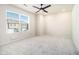 Bright bedroom with a ceiling fan, a large window and neutral carpet at 915 Highwood Ln, Atlanta, GA 30344