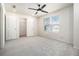 Bright bedroom with neutral carpet, a ceiling fan, and walk-in closet at 915 Highwood Ln, Atlanta, GA 30344