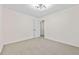 Spacious bedroom with neutral carpeting and modern light fixture at 1008 King Rd, Riverdale, GA 30296