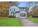 Two-story house with newly landscaped lawn and driveway at 1008 King Rd, Riverdale, GA 30296