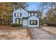 Newly painted light blue two-story house with a driveway at 1008 King Rd, Riverdale, GA 30296