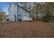 Light blue house exterior with deck, surrounded by autumnal trees at 1008 King Rd, Riverdale, GA 30296
