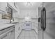 Renovated kitchen featuring white cabinets and new appliances at 1008 King Rd, Riverdale, GA 30296
