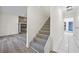 Carpeted staircase with view of living room and tiled hallway at 1008 King Rd, Riverdale, GA 30296