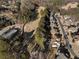 Aerial view of houses backing onto a golf course and surrounded by mature trees in a suburban neighborhood at 183 Applewood Ln, Acworth, GA 30101