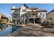 Back exterior of home shows pool, covered deck and lower patio with seating at 183 Applewood Ln, Acworth, GA 30101