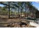 Backyard featuring a large swimming pool and hot tub, mature trees, and peaceful landscaping at 183 Applewood Ln, Acworth, GA 30101