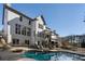 Back exterior of home shows pool, covered deck and lower patio with seating at 183 Applewood Ln, Acworth, GA 30101