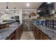 Wet bar area with liquor shelves, tile backsplash, granite countertops, and wooden cabinetry at 183 Applewood Ln, Acworth, GA 30101