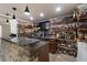 Basement bar with granite counters, custom cabinets, and decorative wall shelving at 183 Applewood Ln, Acworth, GA 30101