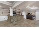 Basement wet bar with stone base, shelving, pendant lights, and tile floors at 183 Applewood Ln, Acworth, GA 30101