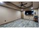 Finished basement with gray wood flooring, entertainment area, and recessed lighting at 183 Applewood Ln, Acworth, GA 30101