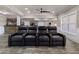Basement media room with leather seating, hardwood floors, and stone-accent wet bar at 183 Applewood Ln, Acworth, GA 30101