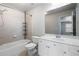 Bathroom features tile flooring, bathtub and shower combo, and vanity with sink and mirror at 183 Applewood Ln, Acworth, GA 30101