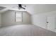 Spacious bedroom with neutral carpet, window, and door to the attic access at 183 Applewood Ln, Acworth, GA 30101