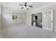 Large bedroom with plush carpeting, neutral walls, plantation shutters, and glass doors at 183 Applewood Ln, Acworth, GA 30101