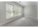 A comfortable bedroom with plush carpet and a view to the outdoors at 183 Applewood Ln, Acworth, GA 30101
