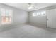 Well lit bedroom with neutral walls, plush carpeting, windows, and a ceiling fan at 183 Applewood Ln, Acworth, GA 30101