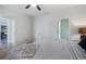 Bright bedroom with doorways leading to bathroom and hallway, ceiling fan, and neutral decor at 183 Applewood Ln, Acworth, GA 30101