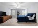 Bright bedroom with a ceiling fan, two windows, blue bed, and a large dresser at 183 Applewood Ln, Acworth, GA 30101