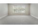 Bright bedroom featuring plush carpeting and a large window view at 183 Applewood Ln, Acworth, GA 30101