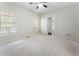 Light-filled bedroom featuring neutral carpet, two windows, and ceiling fan at 183 Applewood Ln, Acworth, GA 30101